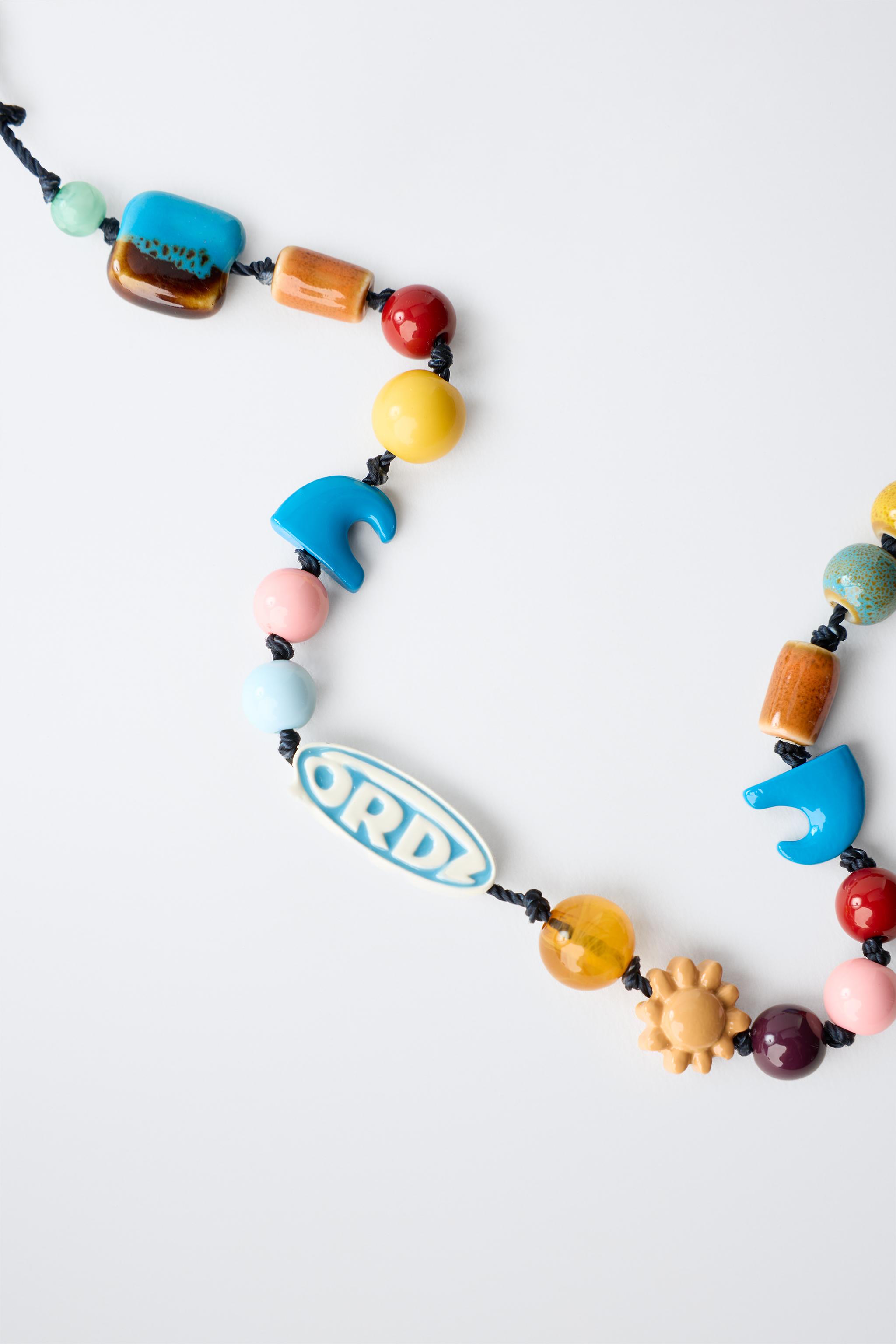 BEADED CORD NECKLACE WITH LOGO